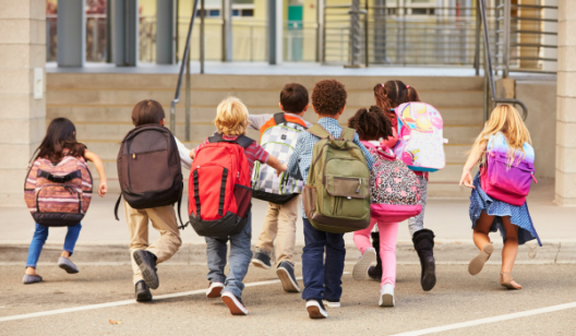 Children running with backpacks on